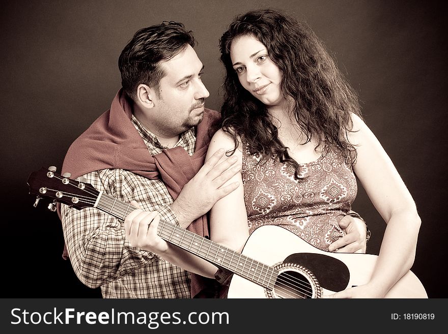 Romantic couple playing the guitar. Romantic couple playing the guitar