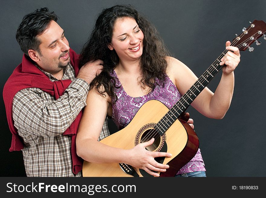 Romantic couple playing the guitar. Romantic couple playing the guitar