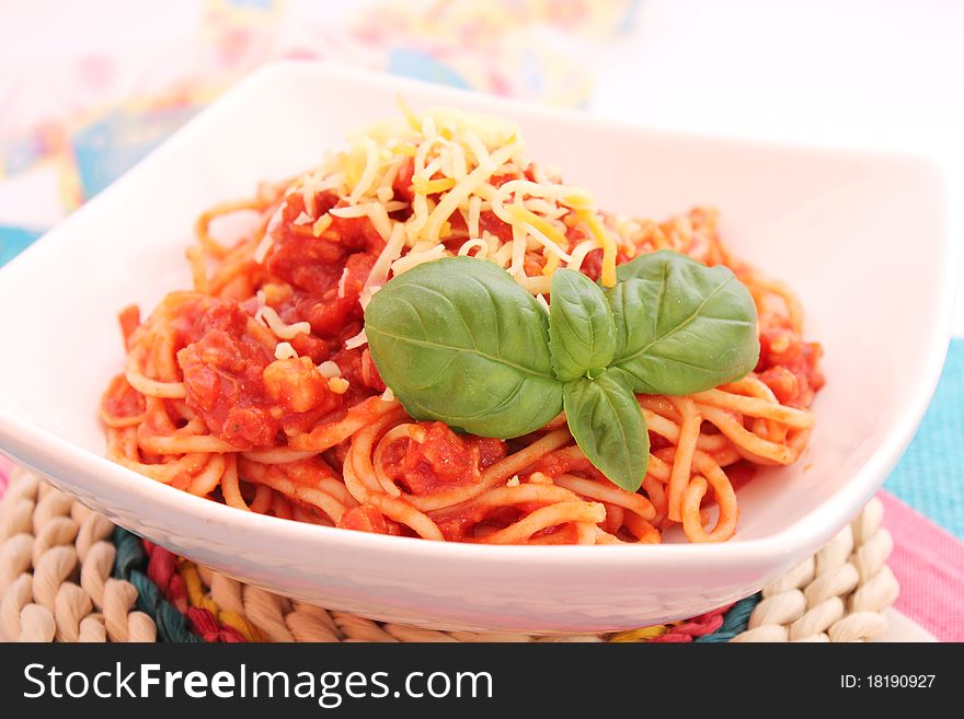 Spaghettis with tomatoes sauce and bacon on a plate