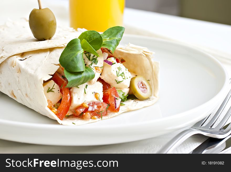 Lavash with a cheese filling, tomato, spinach, olives and a glass of juice. Lavash with a cheese filling, tomato, spinach, olives and a glass of juice.