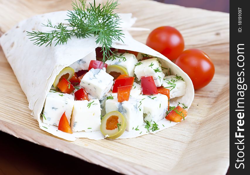 Lavash with a cheese filling, tomato, peppers, olives and fennel. Lavash with a cheese filling, tomato, peppers, olives and fennel.