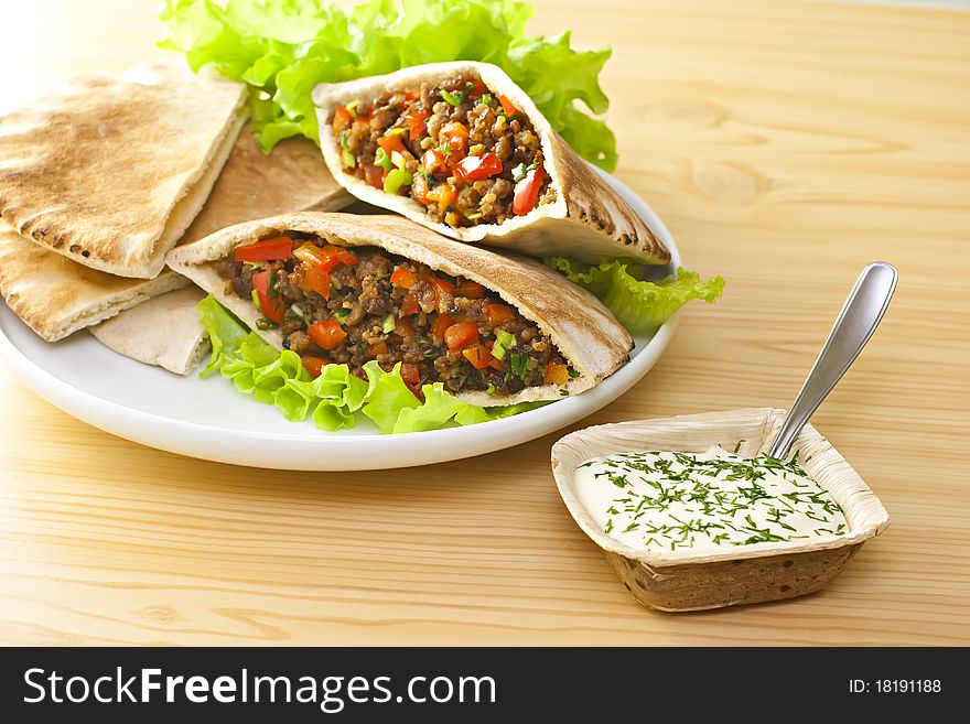 Pita bread with grilled meat and fresh salad. Pita bread with grilled meat and fresh salad.