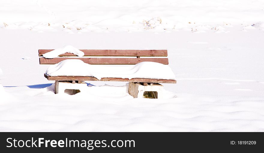 Abandoned bench filled with snow. Abandoned bench filled with snow