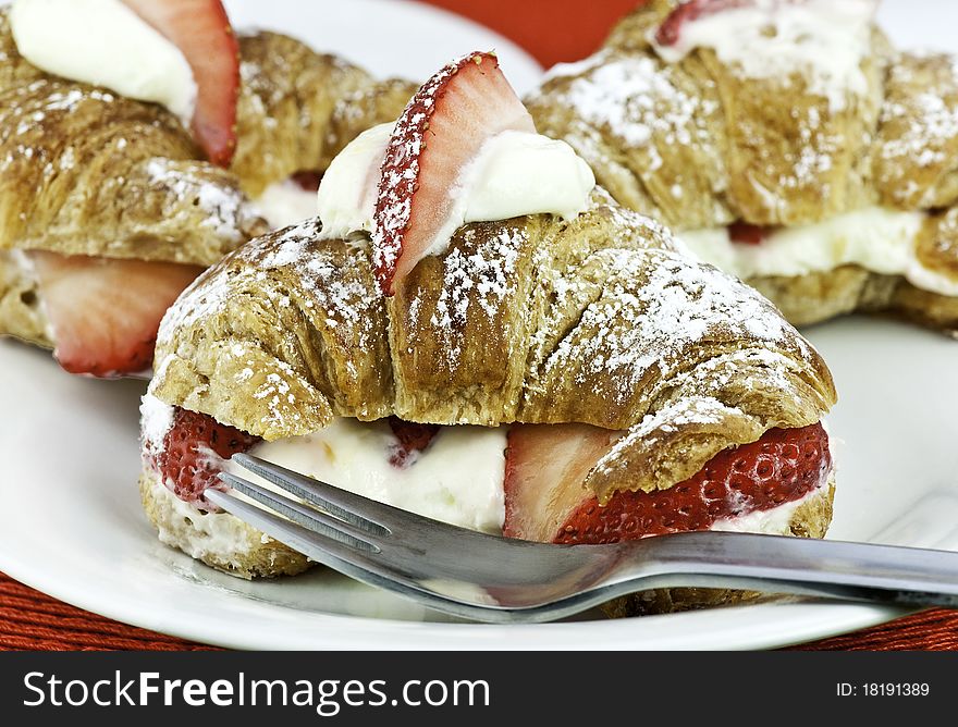 Fresh croissant with strawberries and cream. Fresh croissant with strawberries and cream