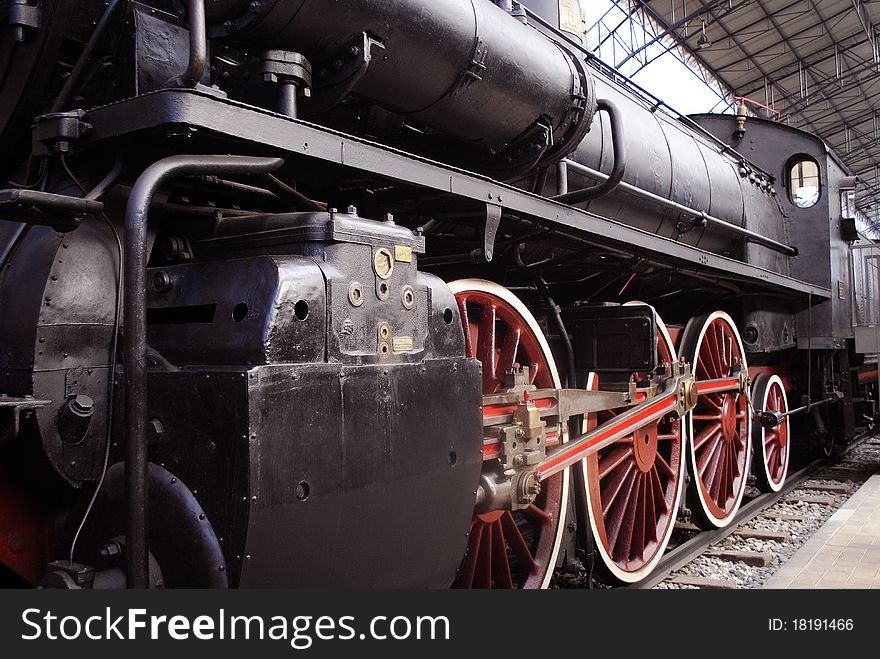 The red steel wheels of a classic steam locomotive. The red steel wheels of a classic steam locomotive.