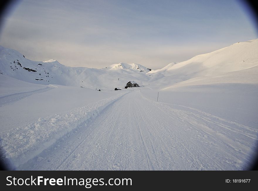 Faraway hut surrounded by snow in the mountains, Dolomites, Italy