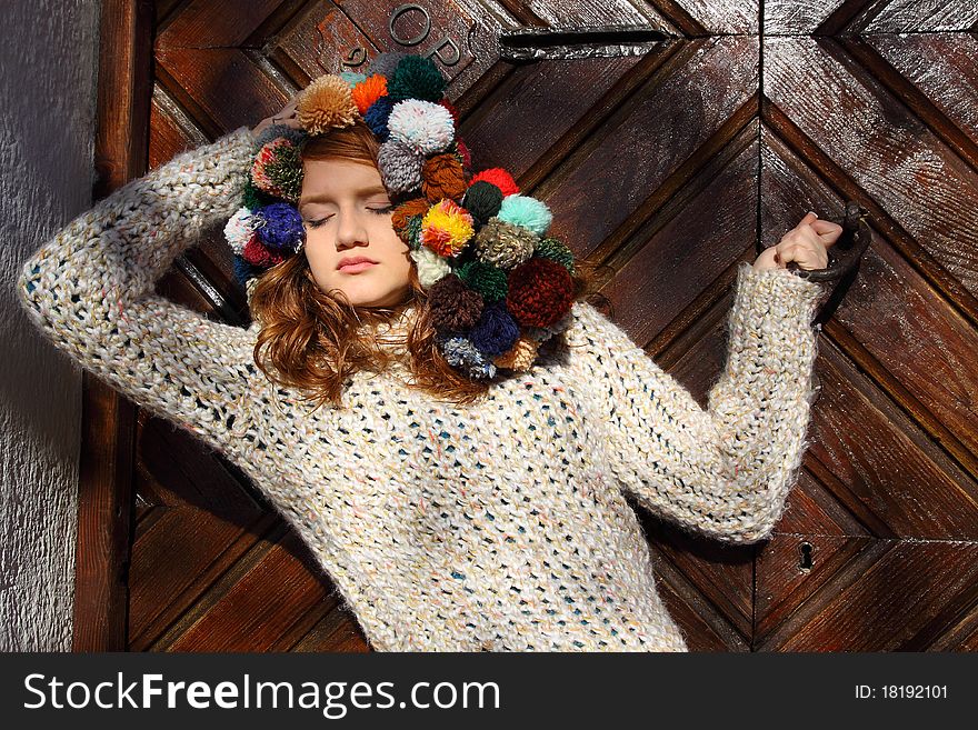 Beautiful redhead young woman in an outdoor fashion pose. Beautiful redhead young woman in an outdoor fashion pose