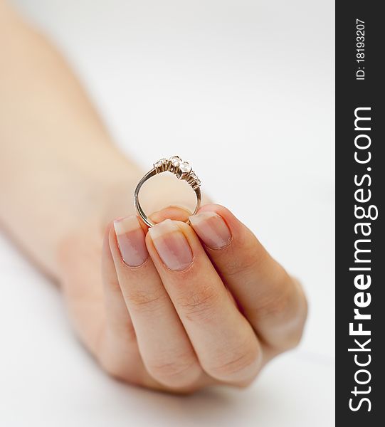 An image of engagement ring held in hand