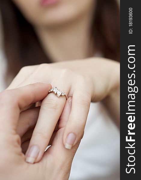 An image of situation of inserting engagement ring into a finger