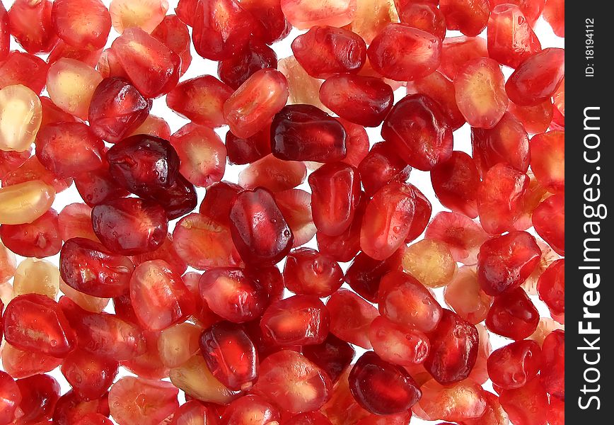 Pomegranate seeds on white background