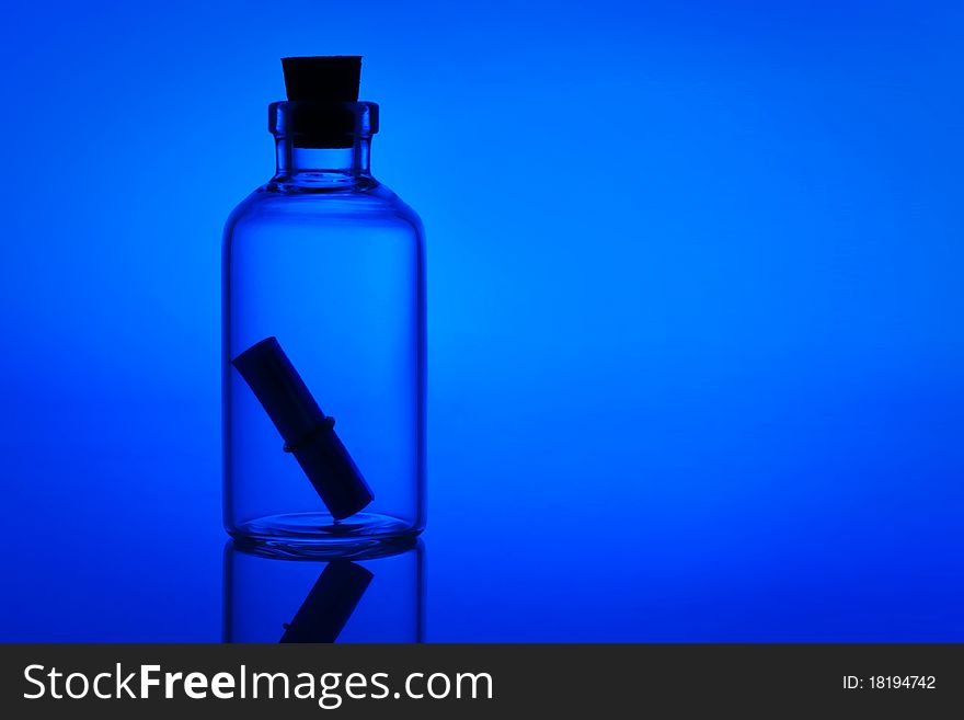 Image of a backlit bottle with a letter inside. Image of a backlit bottle with a letter inside