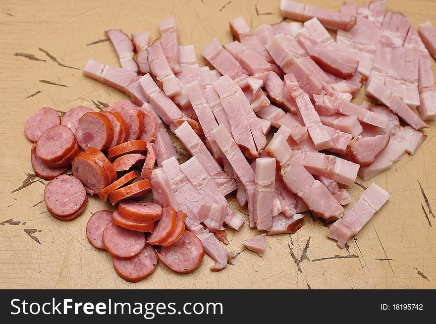 Cut bacon ans sausages prepared for the pizza. Cut bacon ans sausages prepared for the pizza