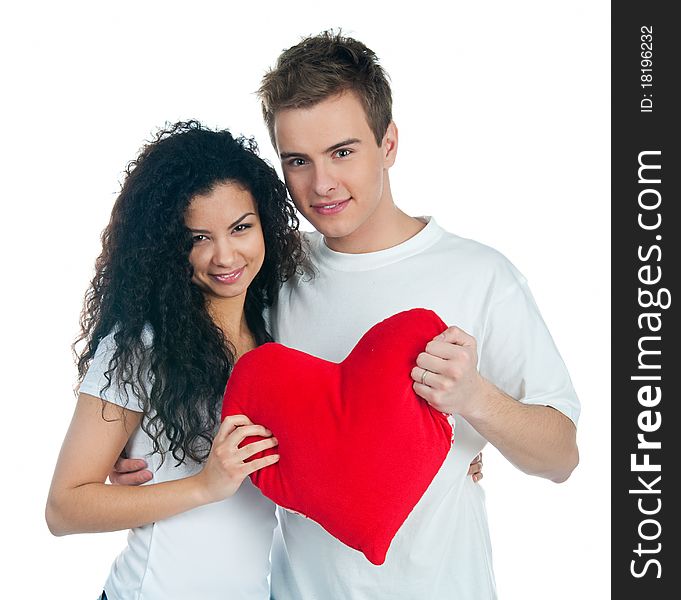 Young couple with a heart over white background