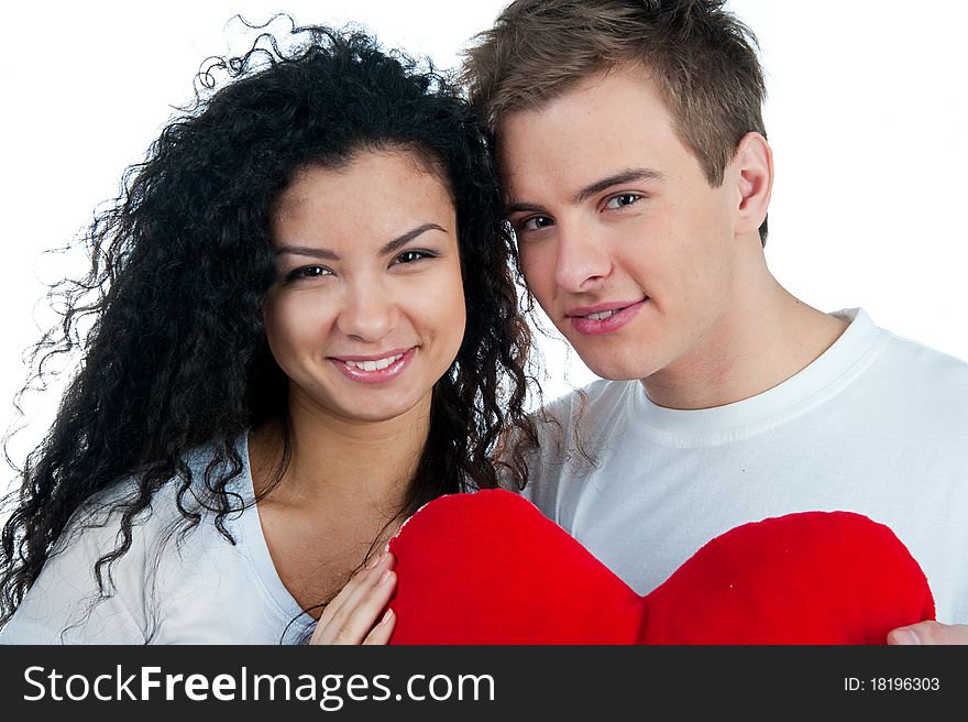 Young couple with a heart over white background