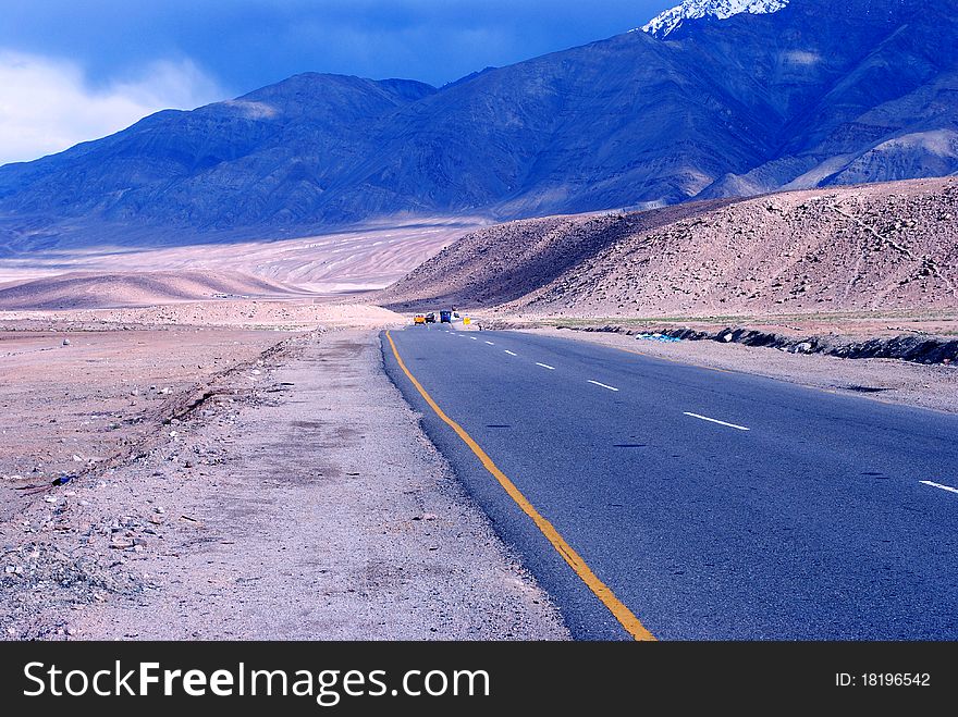 A beautiful scene of a highway and a blue Himalayan mountains. A beautiful scene of a highway and a blue Himalayan mountains.