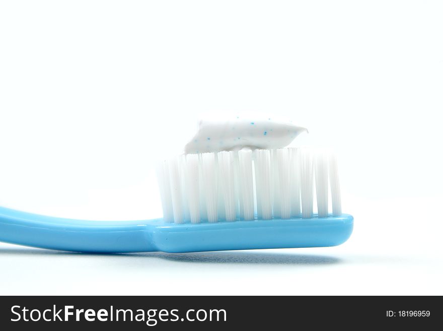 Toothpaste on toothbrush isolated on white background