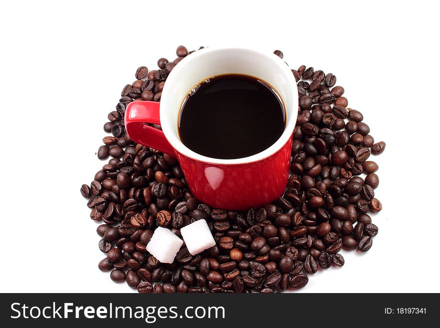 Red mug of coffee with roasted coffee beans and sugar lumps. Red mug of coffee with roasted coffee beans and sugar lumps