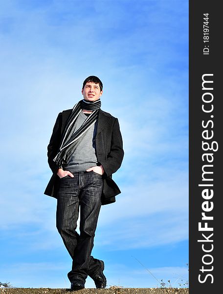 Successful young handsome man outdoor on blue sky