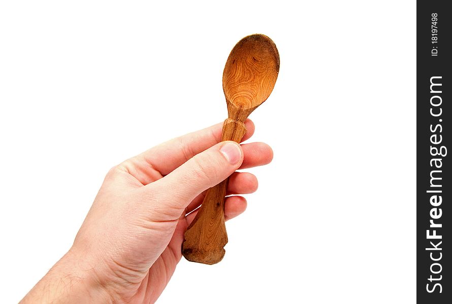 Hand holds a wooden spoon on a white background