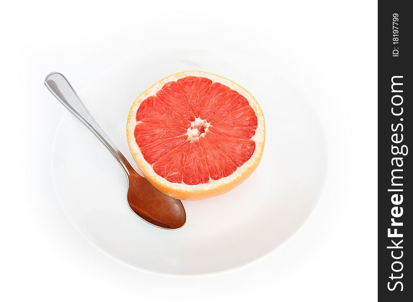 Half grapefruit with plate and spoon, picture from top