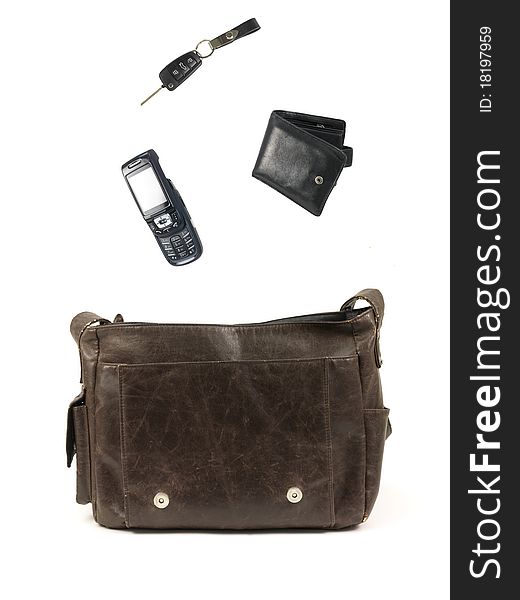 A leather bag and contents isolated against a white background