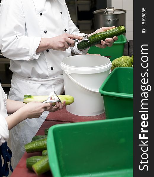 Preparing cucumber for salad in a commercial kitchen. Preparing cucumber for salad in a commercial kitchen
