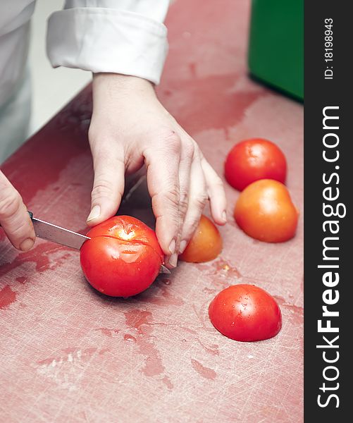 Cutting tomato in a commercial kitchen