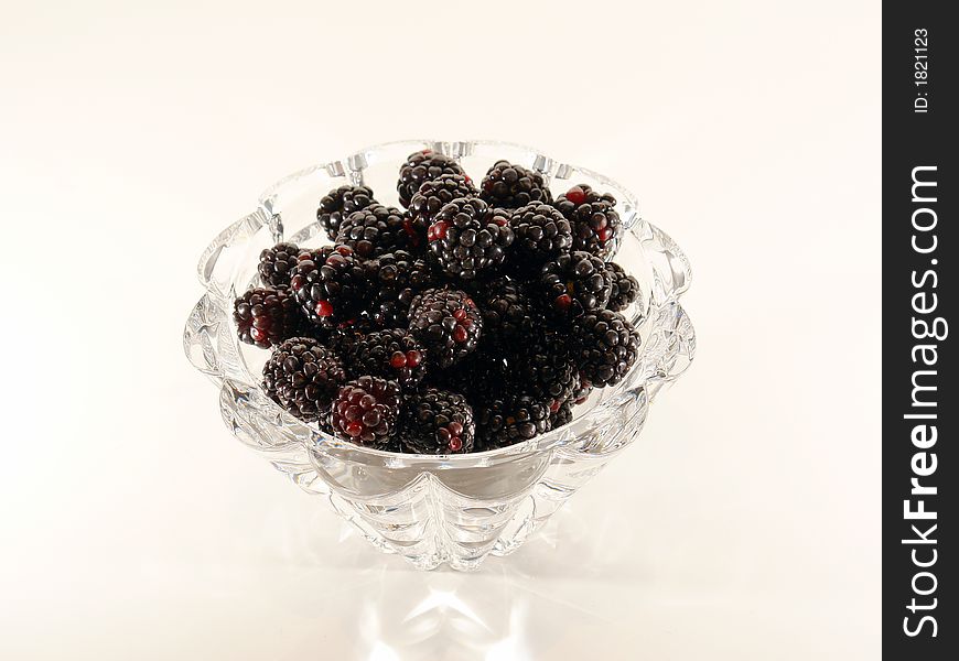 Mound of ripe blackberries against a white background. Mound of ripe blackberries against a white background.