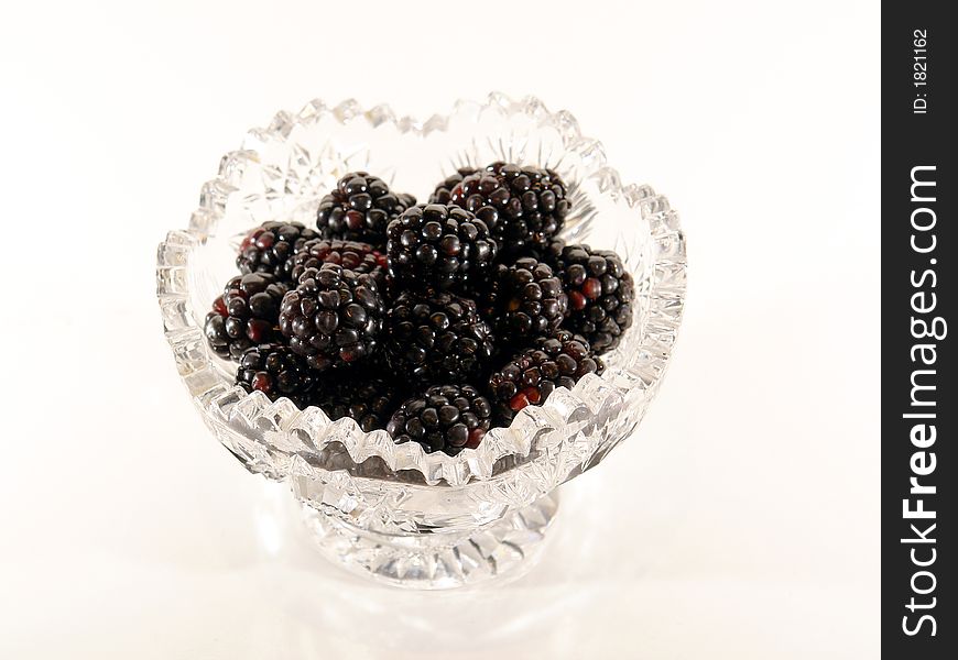 Mound of ripe blackberries against a white background. Mound of ripe blackberries against a white background.