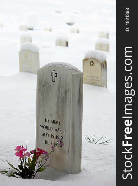 Soldier lies in a cemetery covered in snow. Soldier lies in a cemetery covered in snow