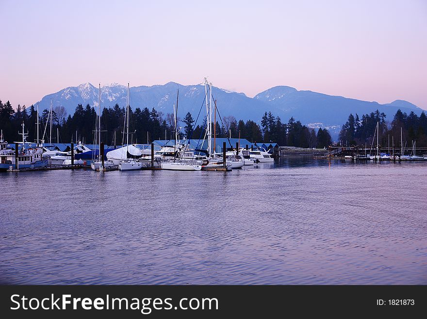 Sailboats moored with mountains in the background. Sailboats moored with mountains in the background