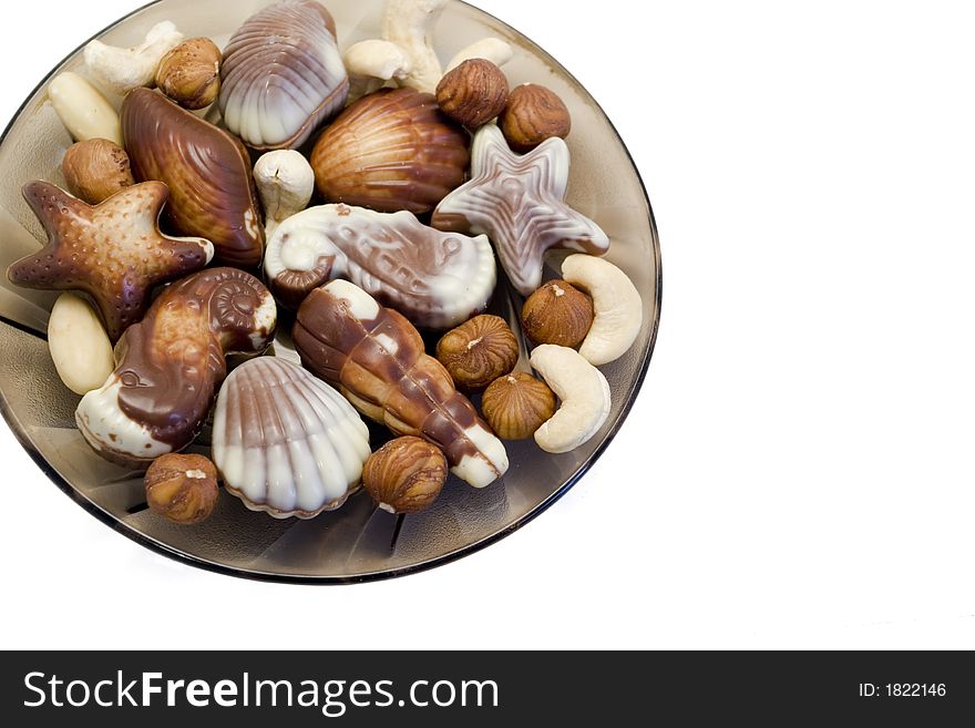 Dessert chocolate truffle candies shaped like seashells with hazel nuts, almonds and cashew nuts. Dessert chocolate truffle candies shaped like seashells with hazel nuts, almonds and cashew nuts