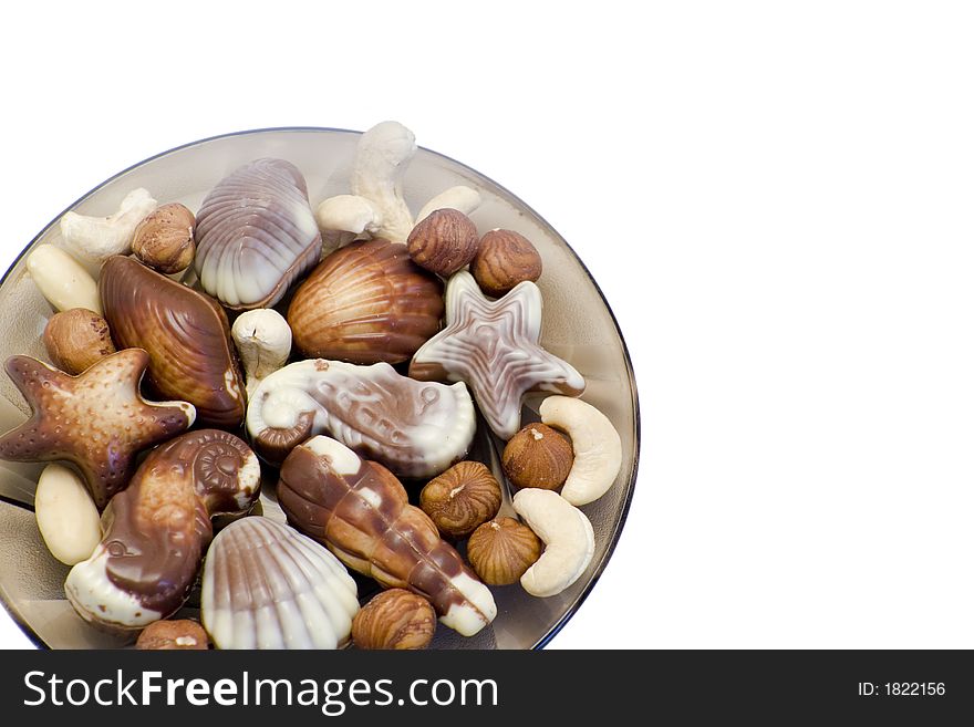 Dessert chocolate truffle candies shaped like seashells with hazel nuts, almonds and cashew nuts. Dessert chocolate truffle candies shaped like seashells with hazel nuts, almonds and cashew nuts