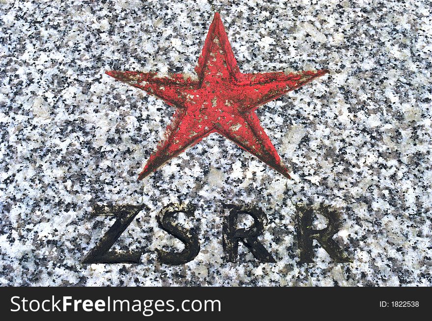 Stone memorial plaque with red star and zsrr sign