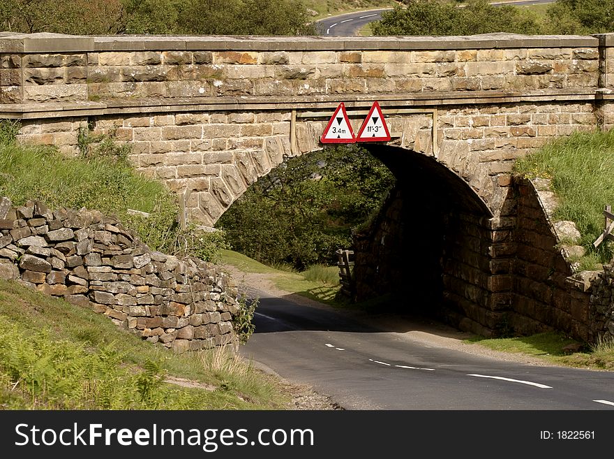 A low bridge on a country lane in North Yorkshire England.