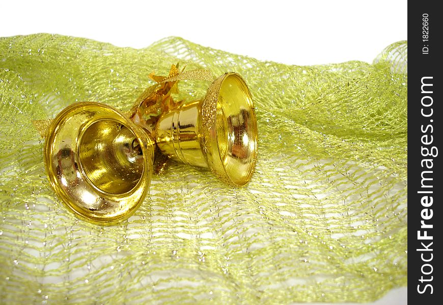 Golden Christmas handbells on green background
