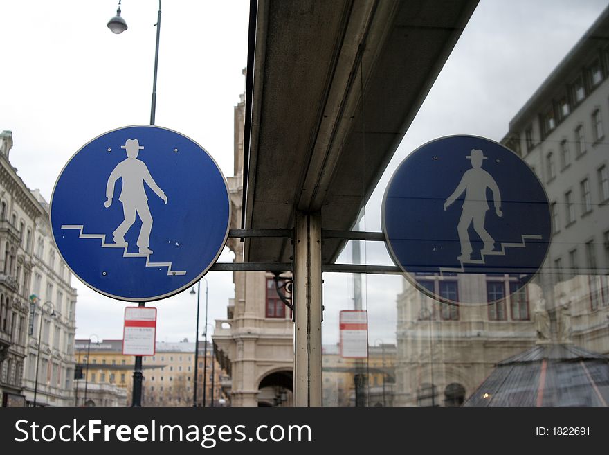 Man walking down stairs symbol for subway entrance, vienna