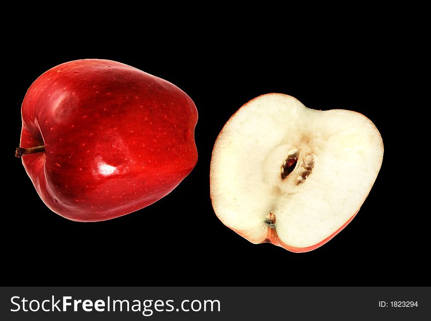 Red Delicious apples, whole and half on black background with clipping path. Red Delicious apples, whole and half on black background with clipping path