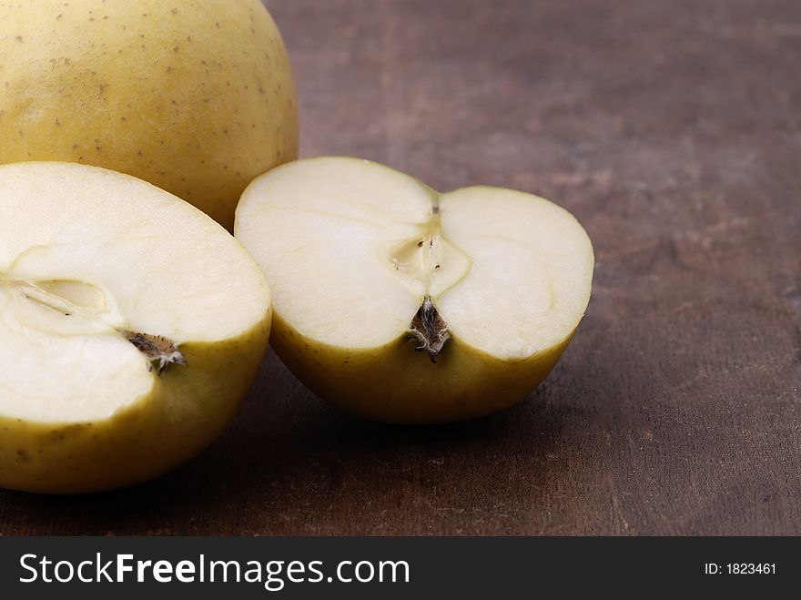 Apples on an aged wooden table/cutting board. Apples on an aged wooden table/cutting board.