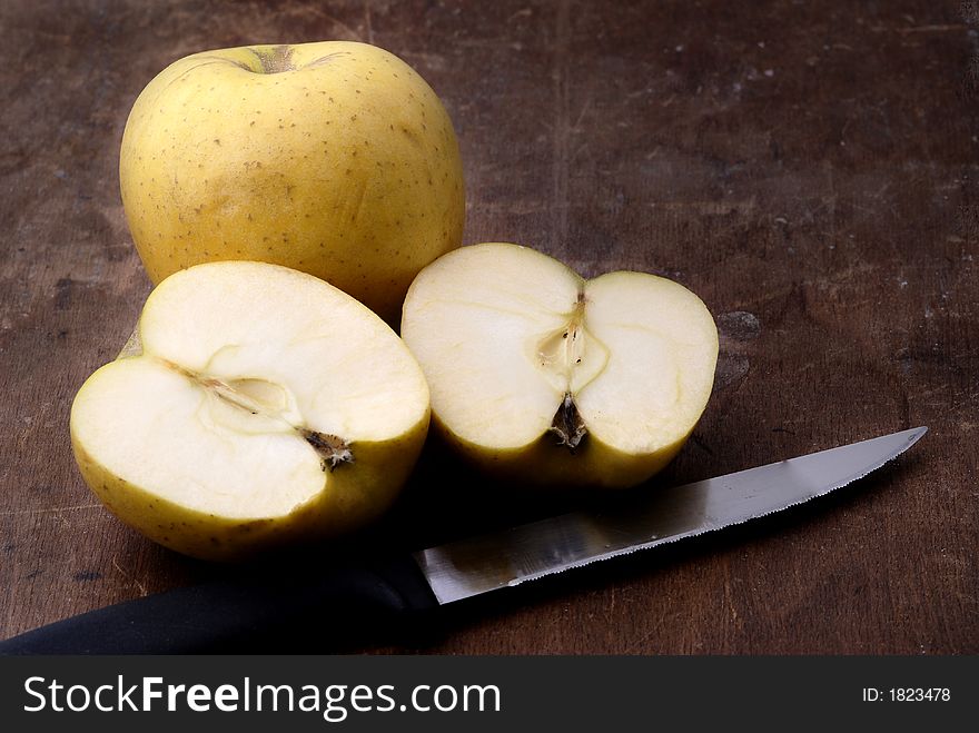 Apples on an aged wooden table/cutting board. Apples on an aged wooden table/cutting board.