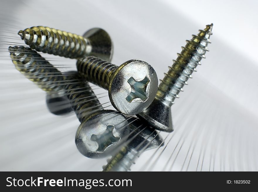 Three screws on metallic background close up shoot