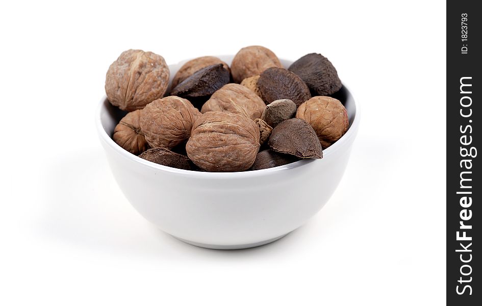 A bowl of mixed nuts isolated against white. A bowl of mixed nuts isolated against white.