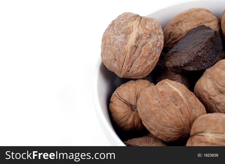 A bowl of mixed nuts isolated against white. A bowl of mixed nuts isolated against white.