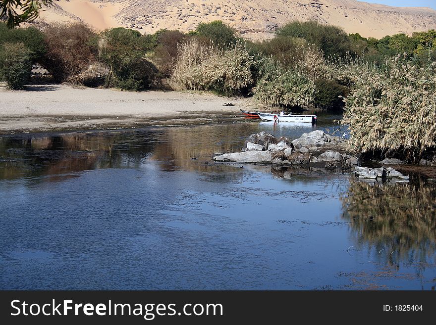 A beautiful scene of the meeting between the desert and the green plants on one of the many islands located within river Nile in Aswan of upper Egypt. A beautiful scene of the meeting between the desert and the green plants on one of the many islands located within river Nile in Aswan of upper Egypt.