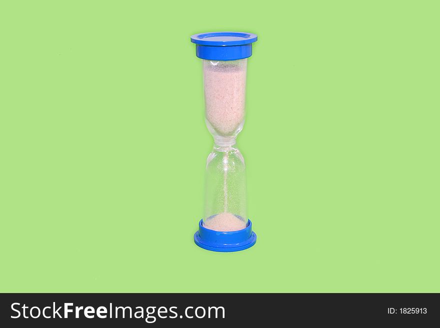 Hourglass counting the time isolated over green