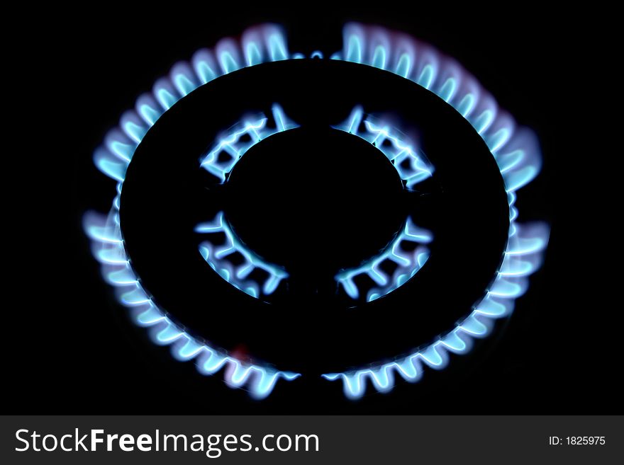 Blue flames form a gas fire in a stove. Blue flames form a gas fire in a stove