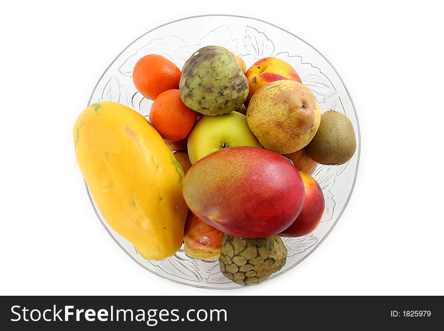 Glass bowl full of fruits isolated over white. Glass bowl full of fruits isolated over white