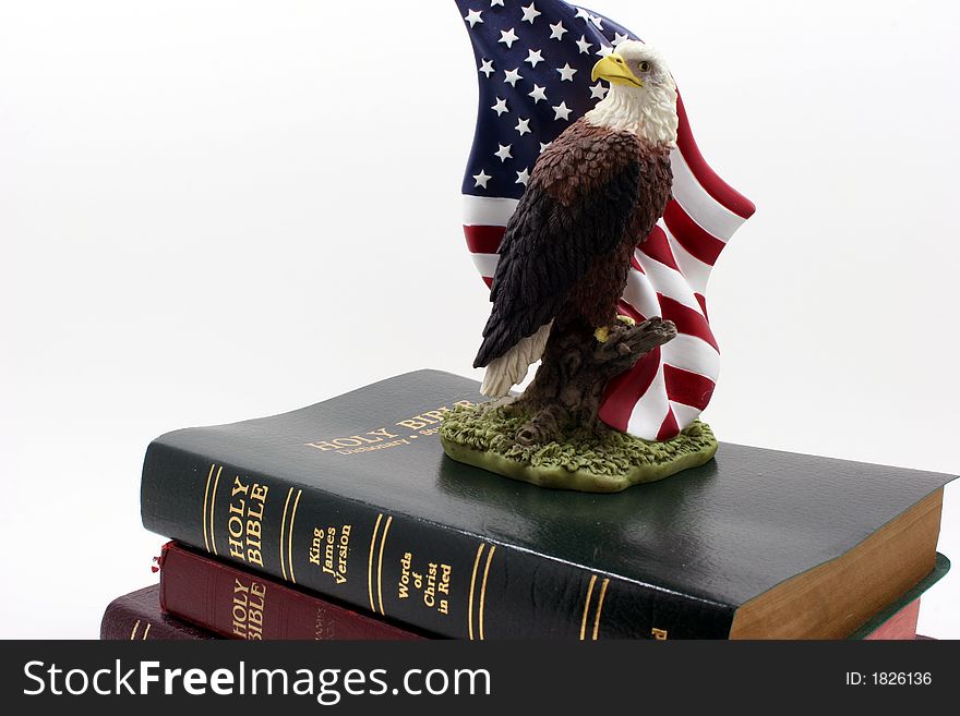 An eagle statuette on top of three bibles. An eagle statuette on top of three bibles