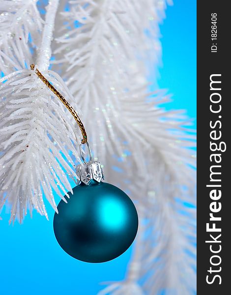 Blue Christmas Ornament hanging on a tree branch.