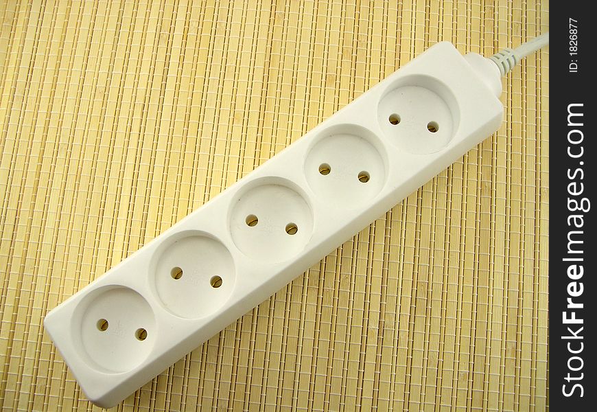 The beautiful socket white on a background of a bamboo napkin. The beautiful socket white on a background of a bamboo napkin